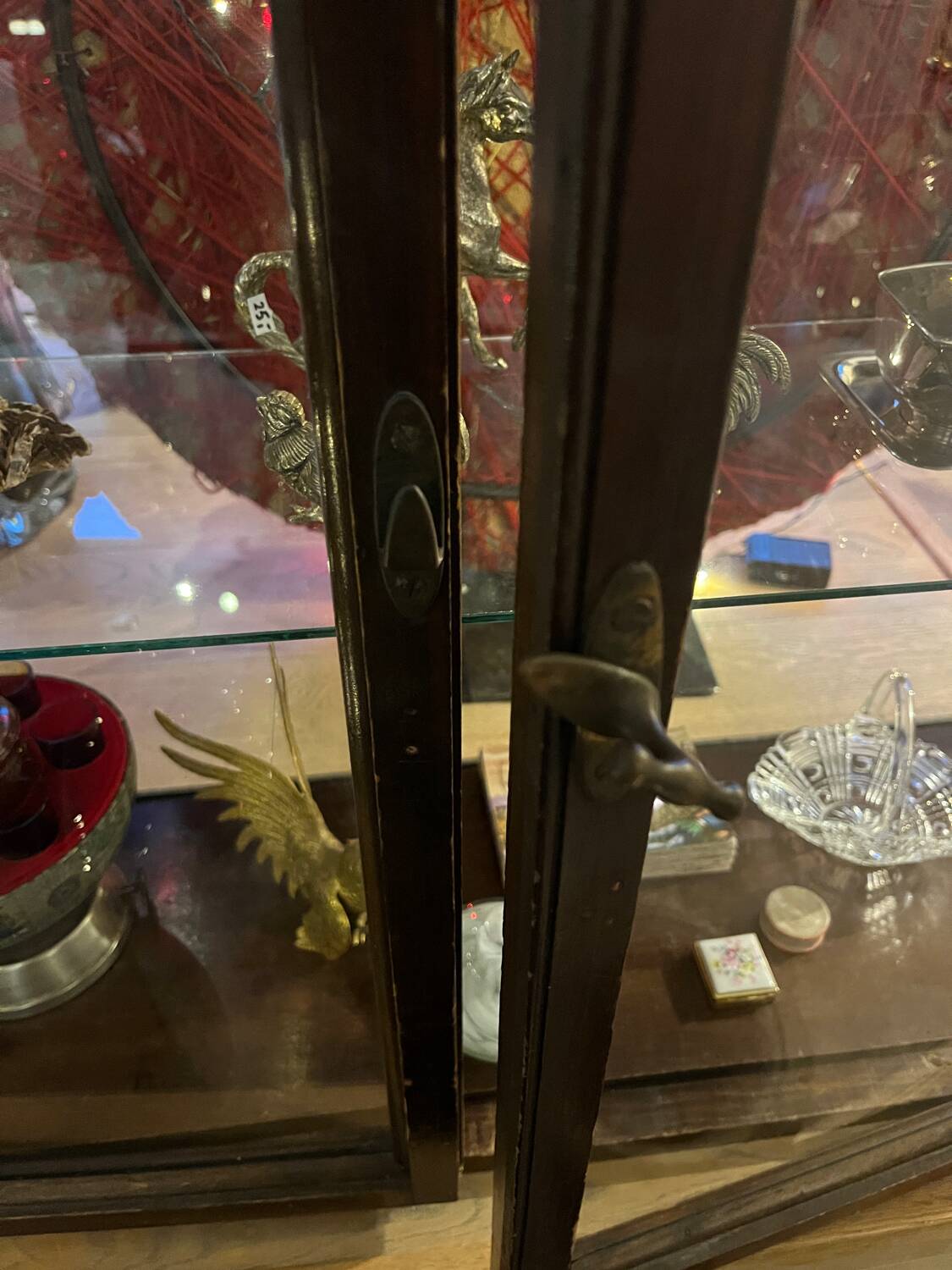 Dark-stained wood and glass vintage display cabinet — early 20th-century wall-mounted showcase