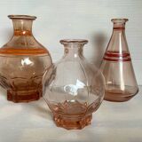 Trio of pink bottle decanters