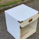 White Scandinavian bedside table in boat style made of wood.