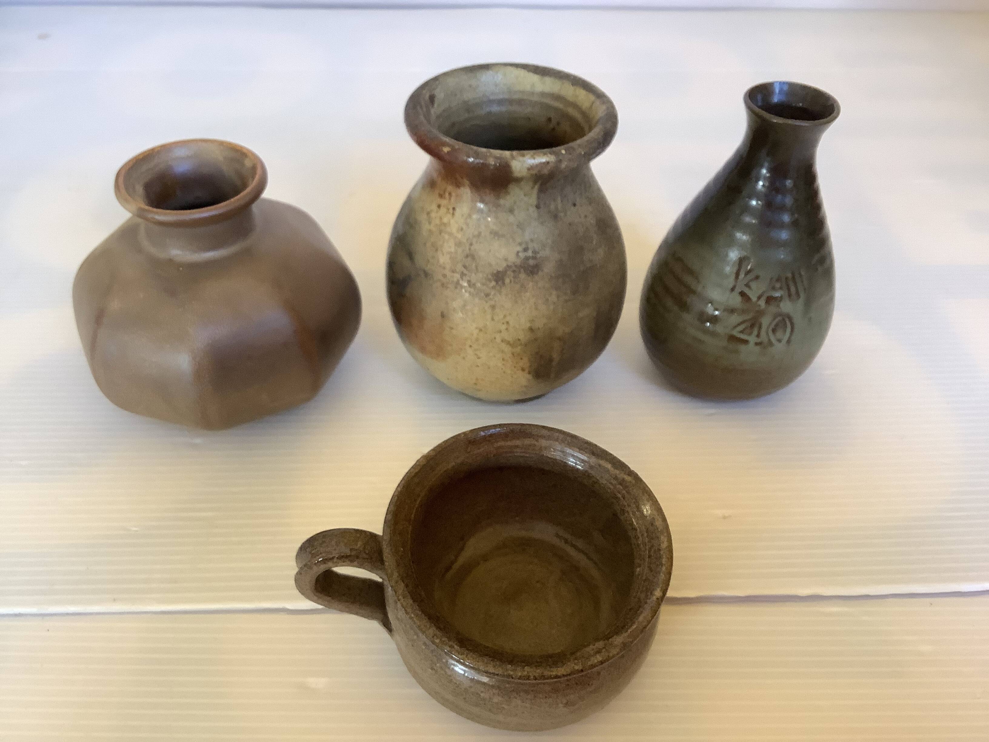 Eight brown ceramic pitcher vases