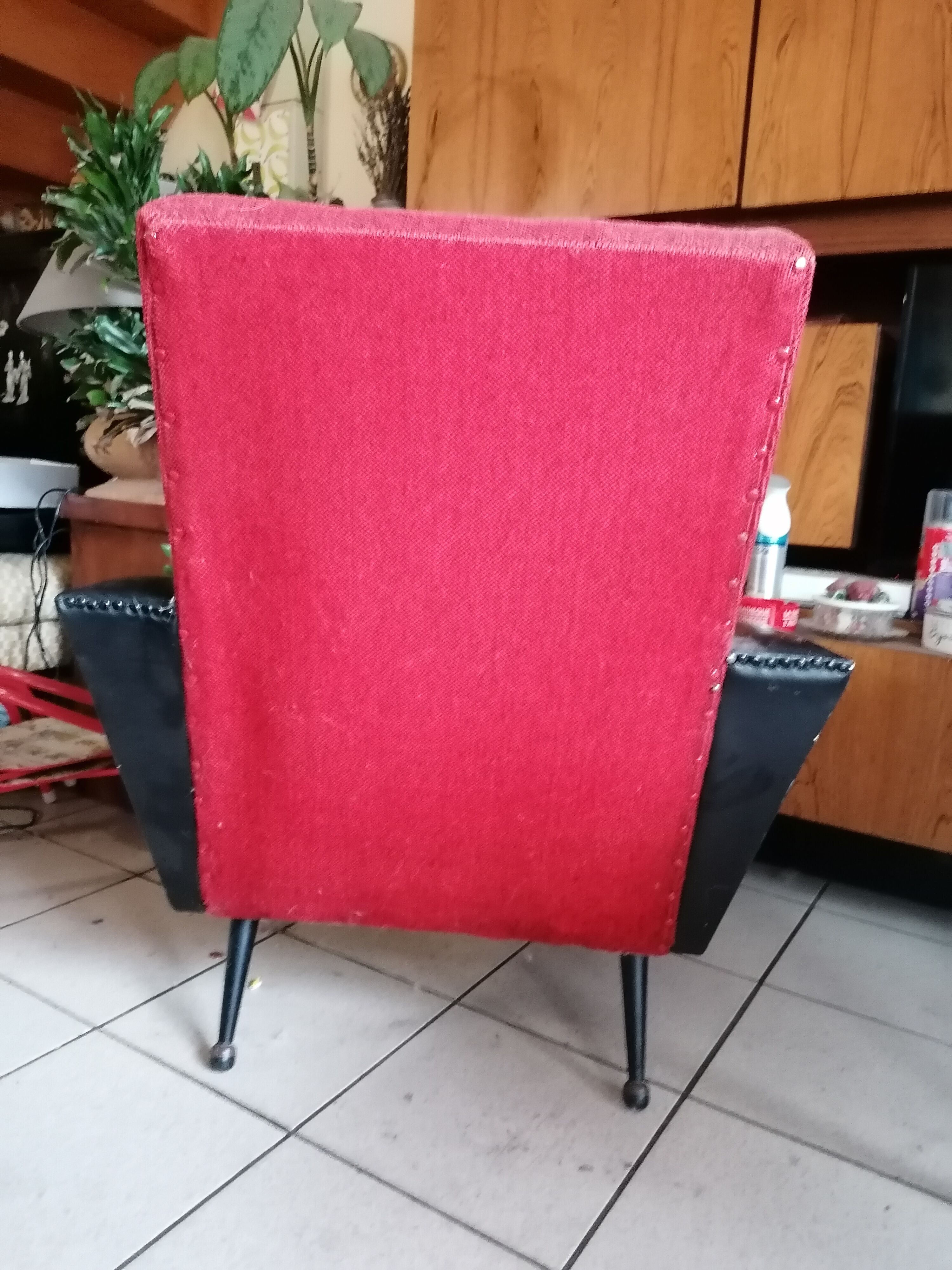 Red and black chair with brass feet
