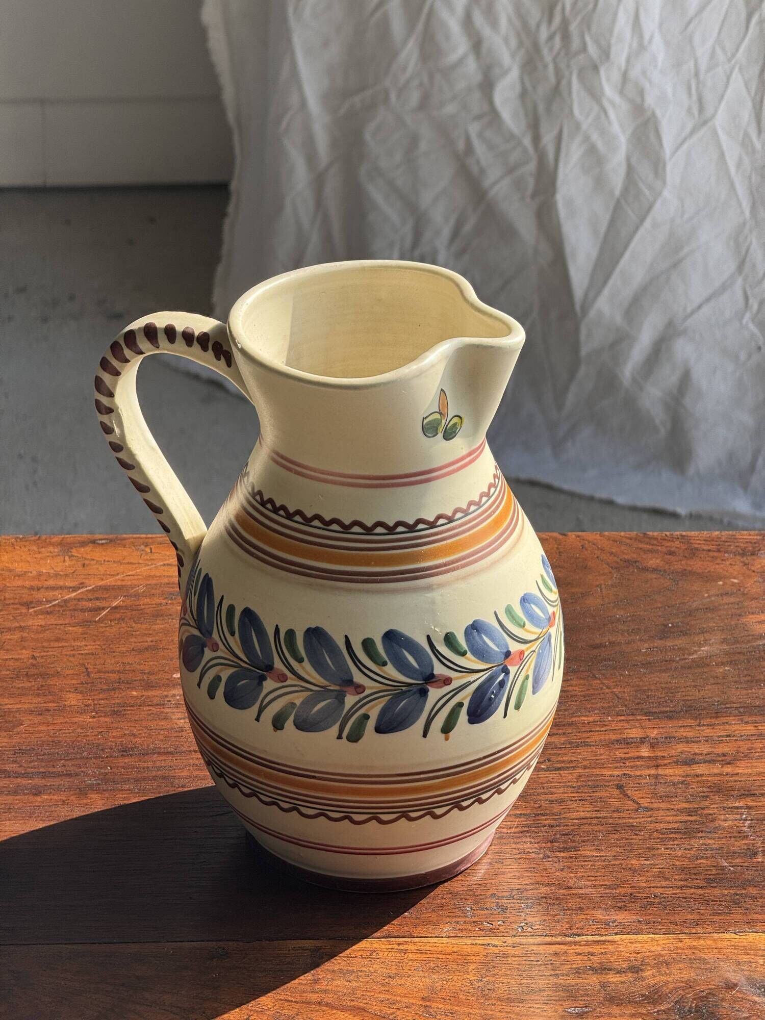 Beige carafe with stylized blue flower friezes