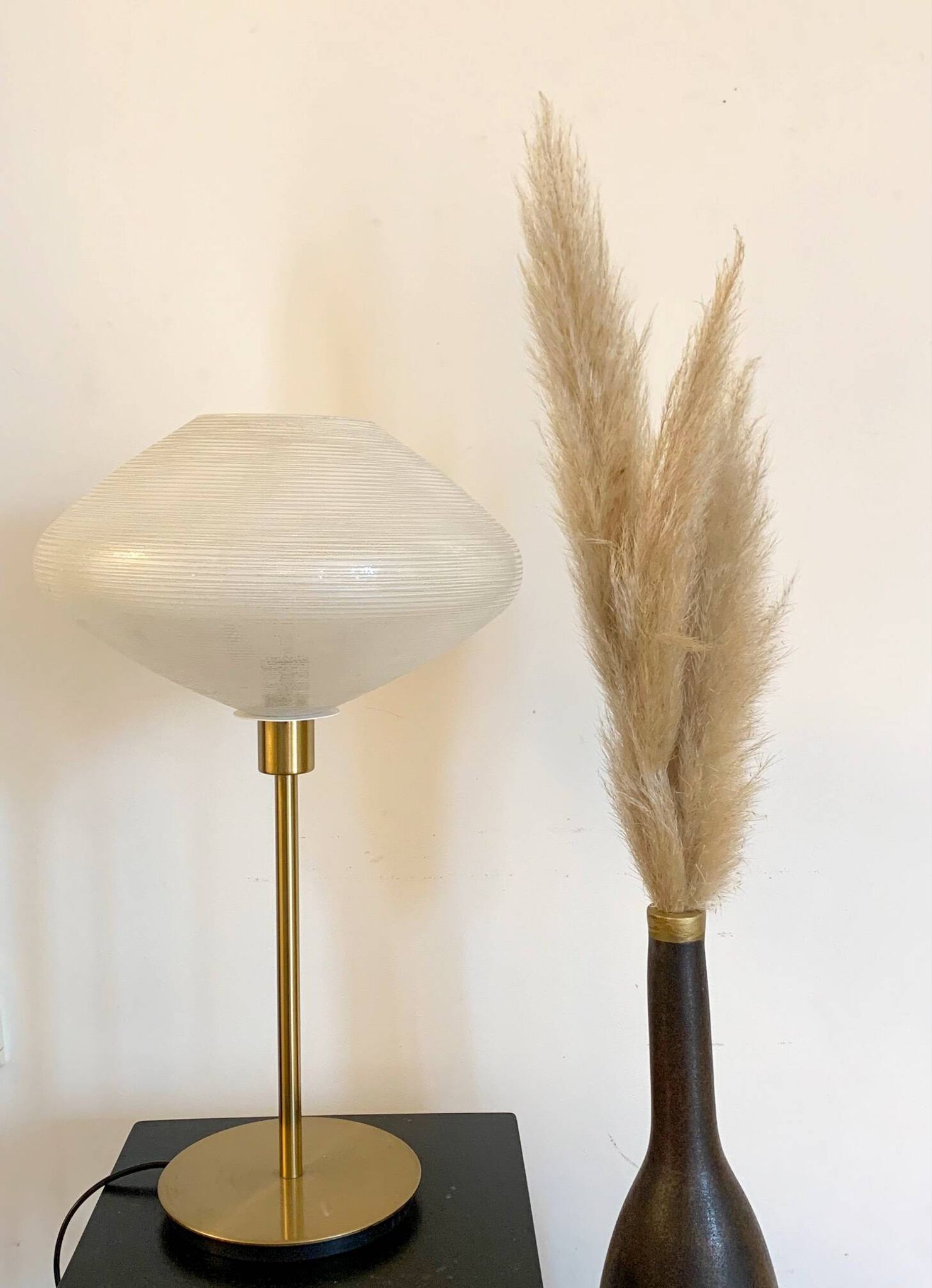 Table lamp with a vintage glass globe and saucer and a golden foot
