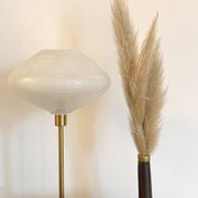 Table lamp with a vintage glass globe and saucer and a golden foot