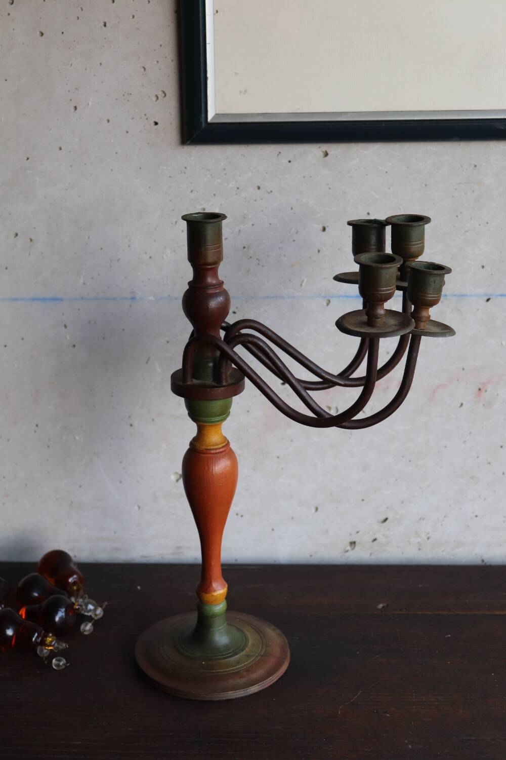 Old candlestick in painted wood and folding metal