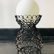 Black wrought iron lamp with a white glass globe.