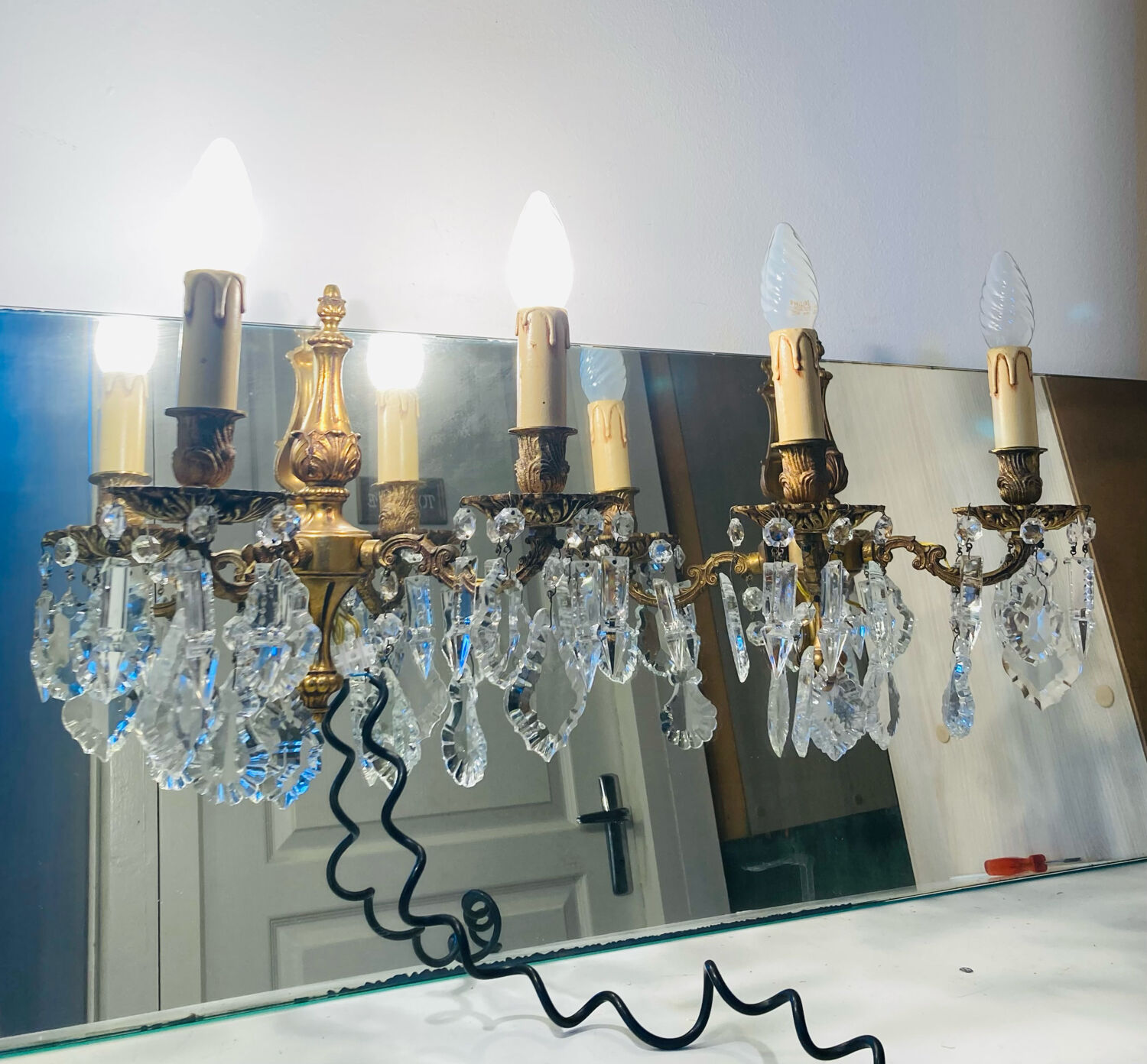 Pair of gilt bronze wall sconces with pendants from the mid-20th century.