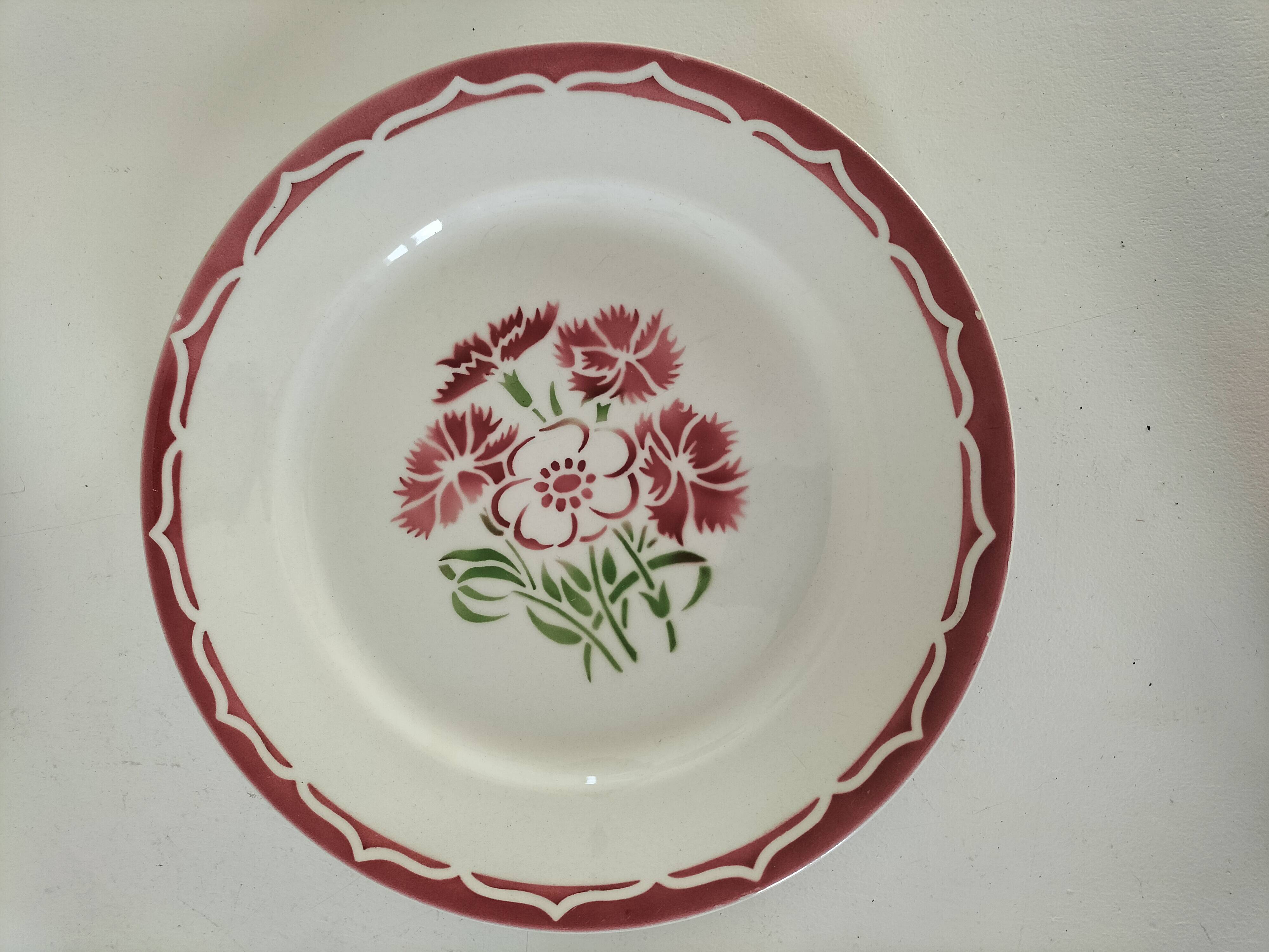 Set of 8 ironstone plates with coordinated designs.