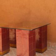 Modern coffee table in burgundy zellige with a tempered glass top.