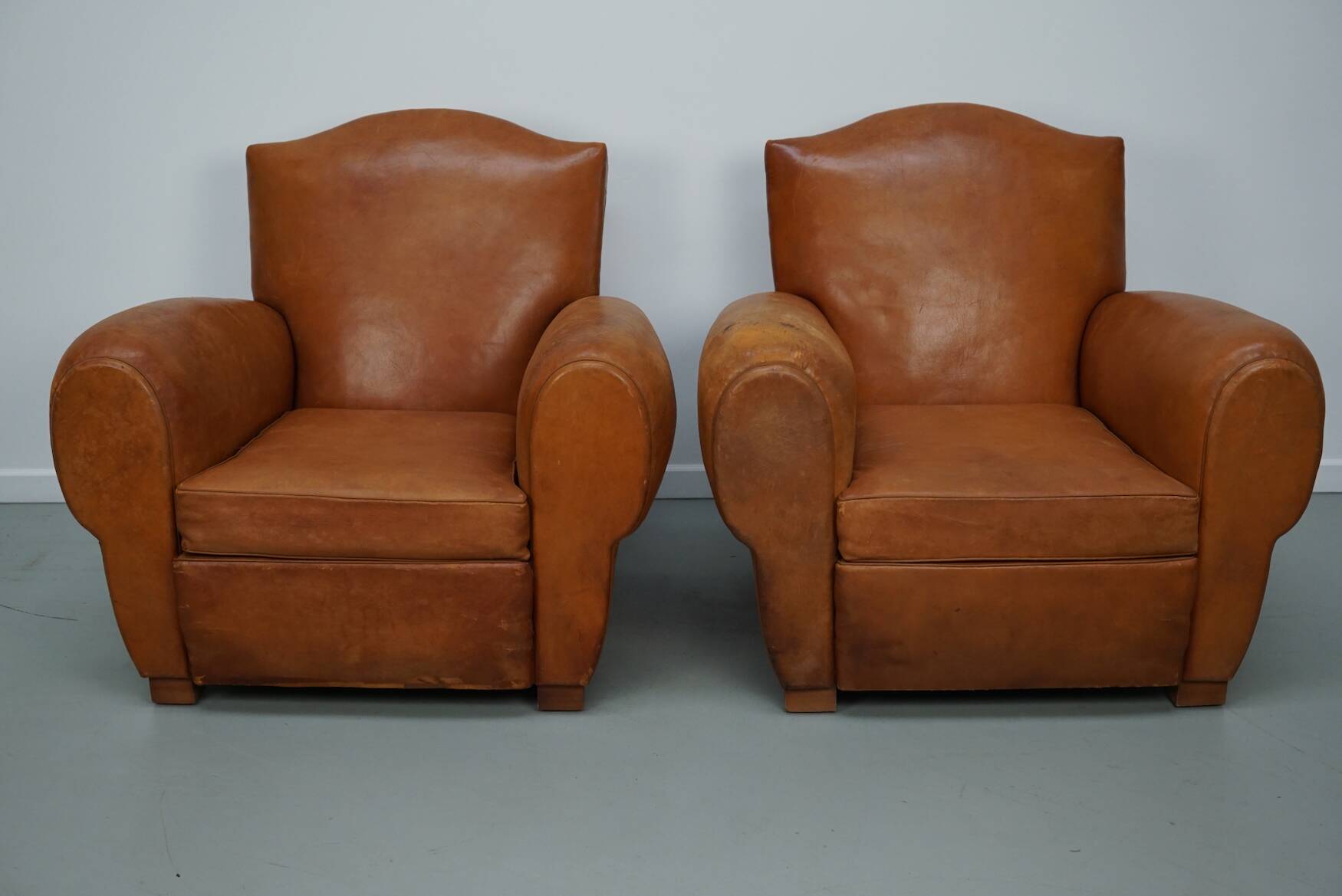Pair of French club chairs with moustache back in cognac leather, 1950s