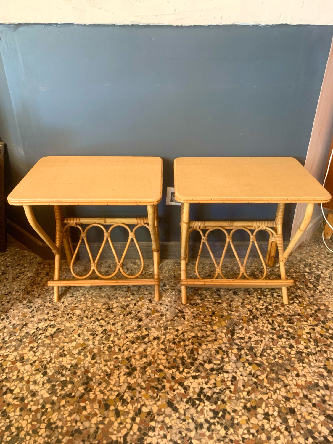 A pair of rattan bedside tables.