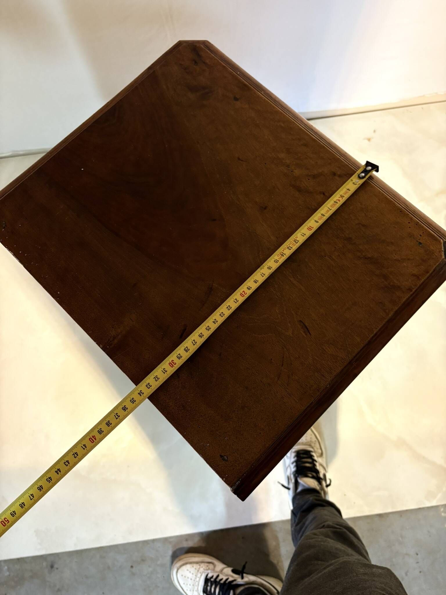 Antique wooden bedside table with turned legs.