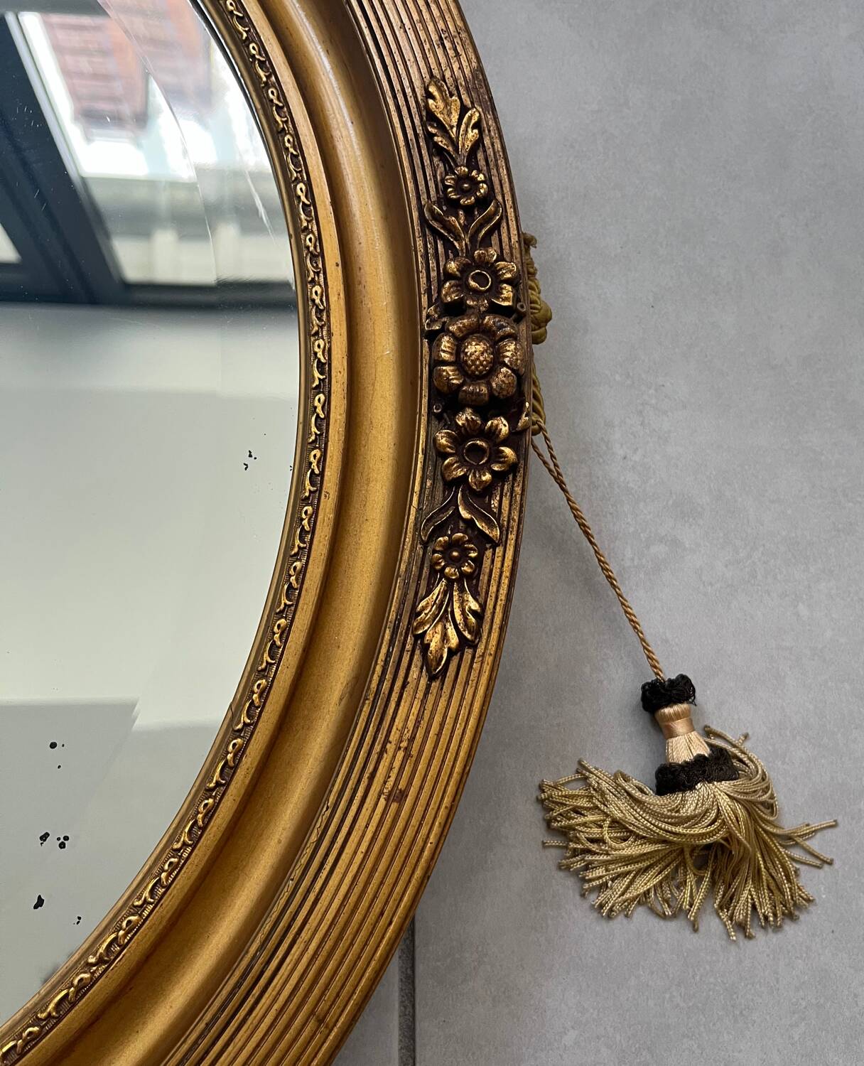 Oval gilt mirror and Art Deco trim