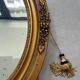 Oval gilt mirror and Art Deco trim