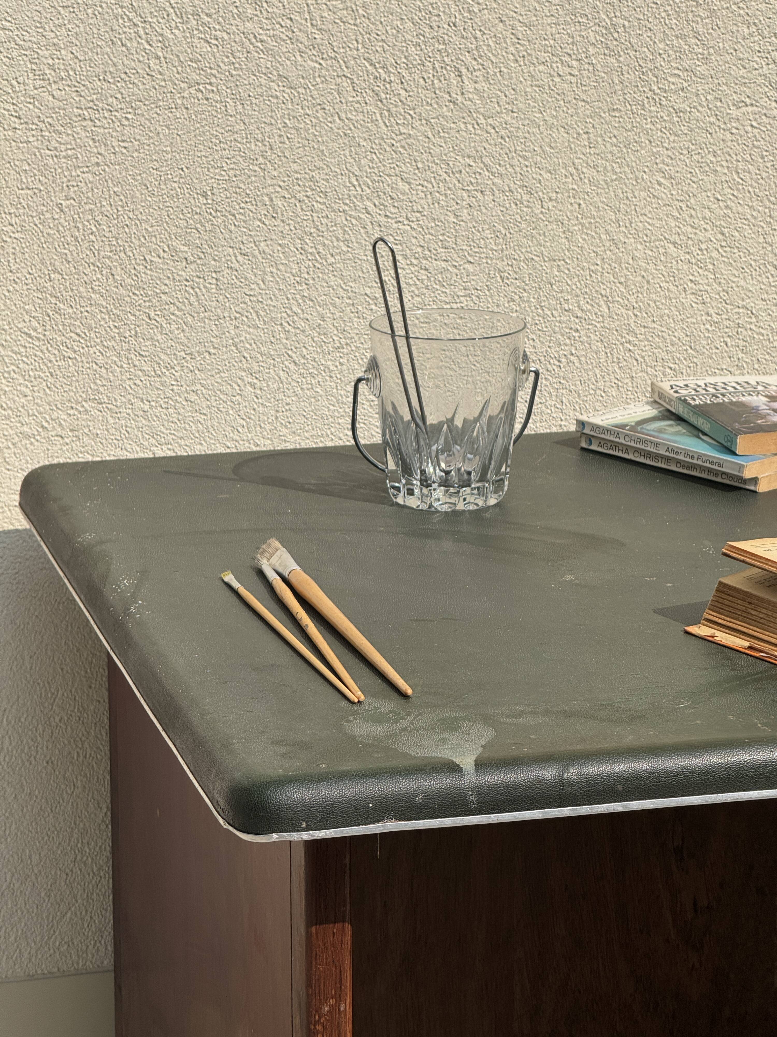 Modernist desk in wood and green moleskin upholstery