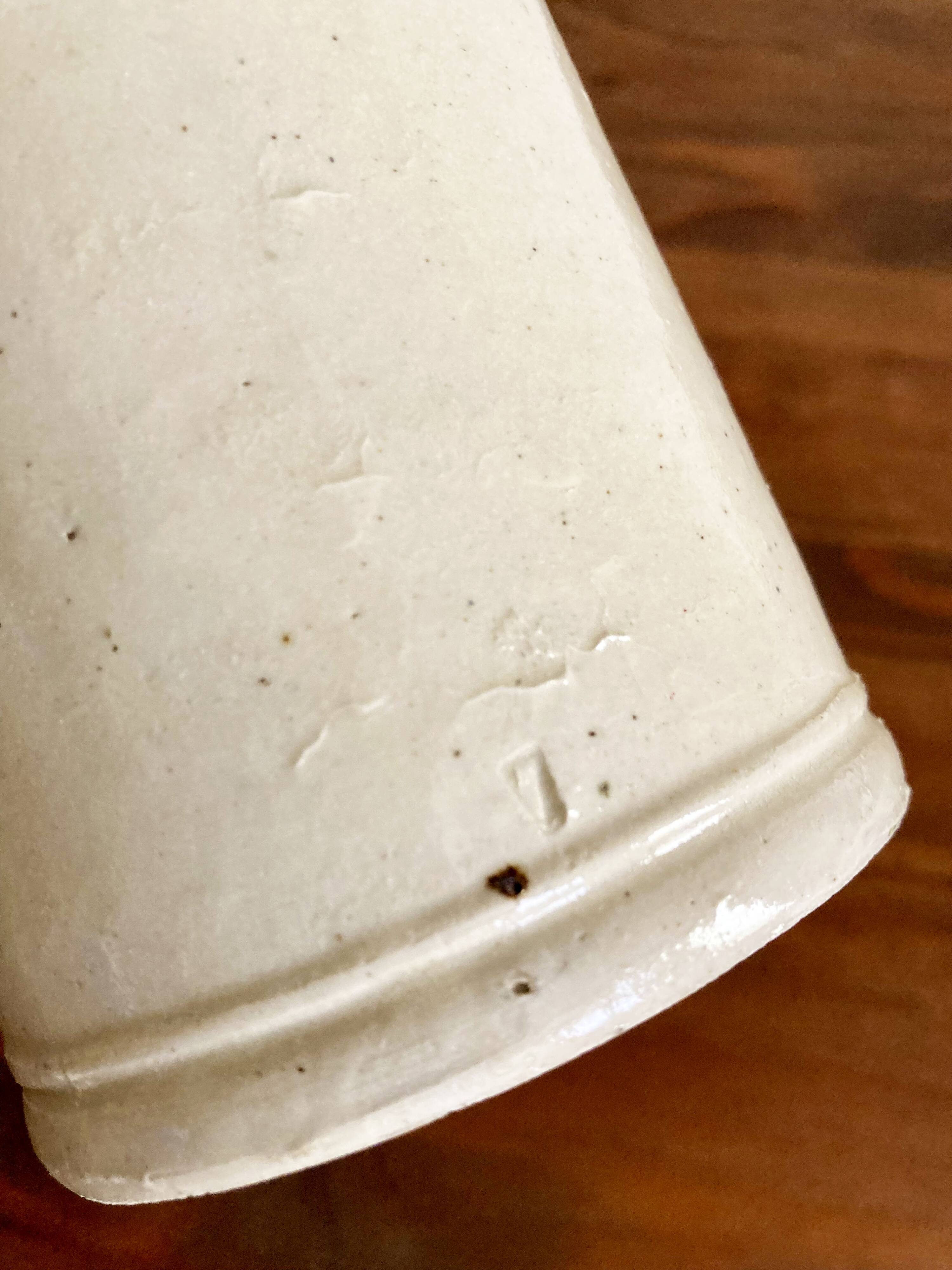 Trio of creamy white glazed stoneware bottles