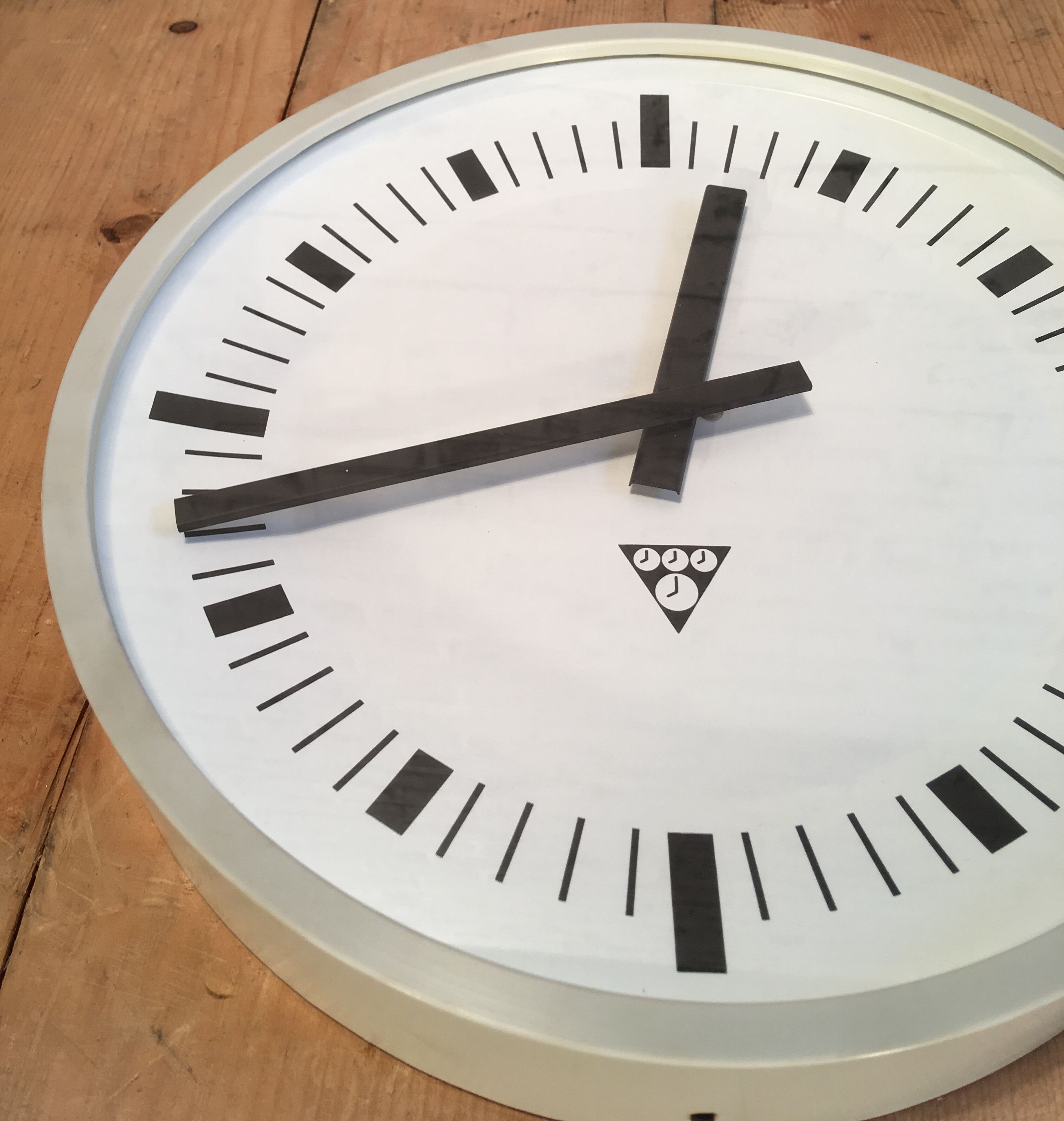 Grey industrial bakelite office wall clock from Pragotron, 1970