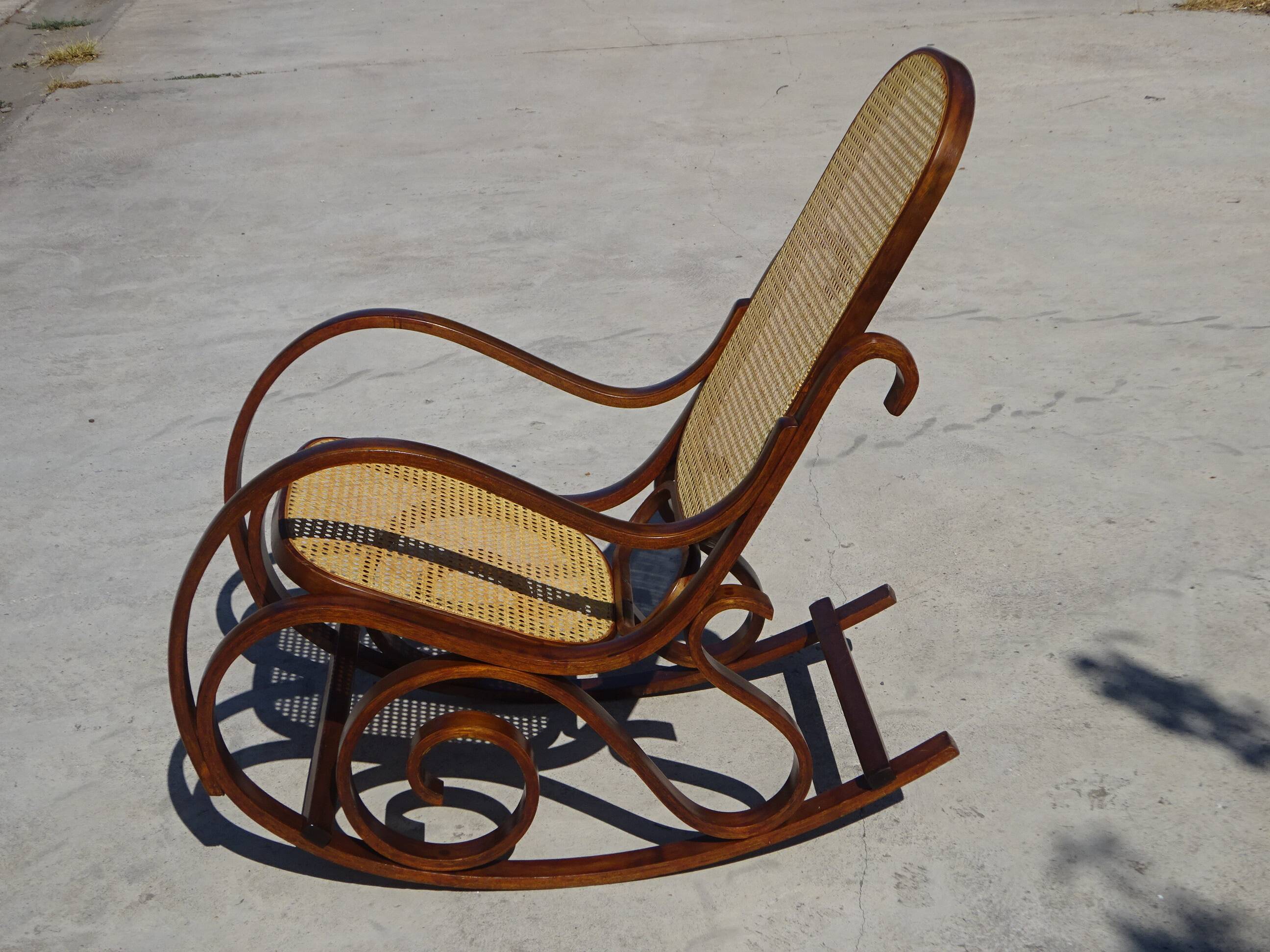Vintage wooden rocking chair with caning