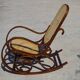 Vintage wooden rocking chair with caning