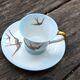 Tasse et sa soucoupe en porcelaine de Limoges motif "hirondelles"
