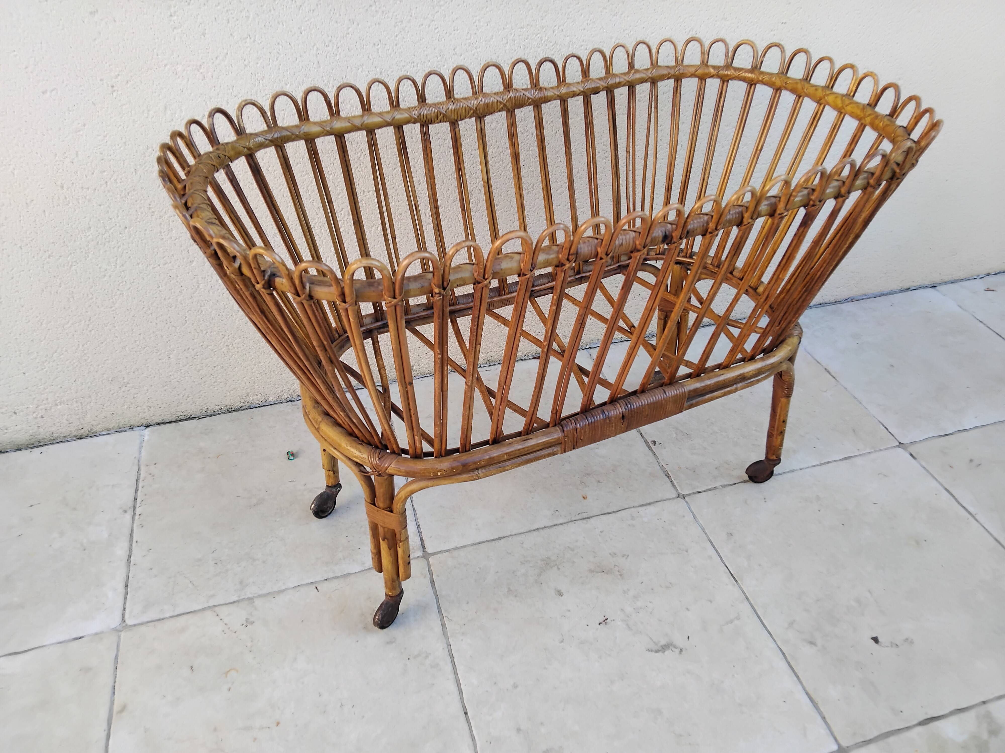 Vintage rattan bed on wheels cradle