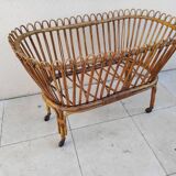 Vintage rattan bed on wheels cradle