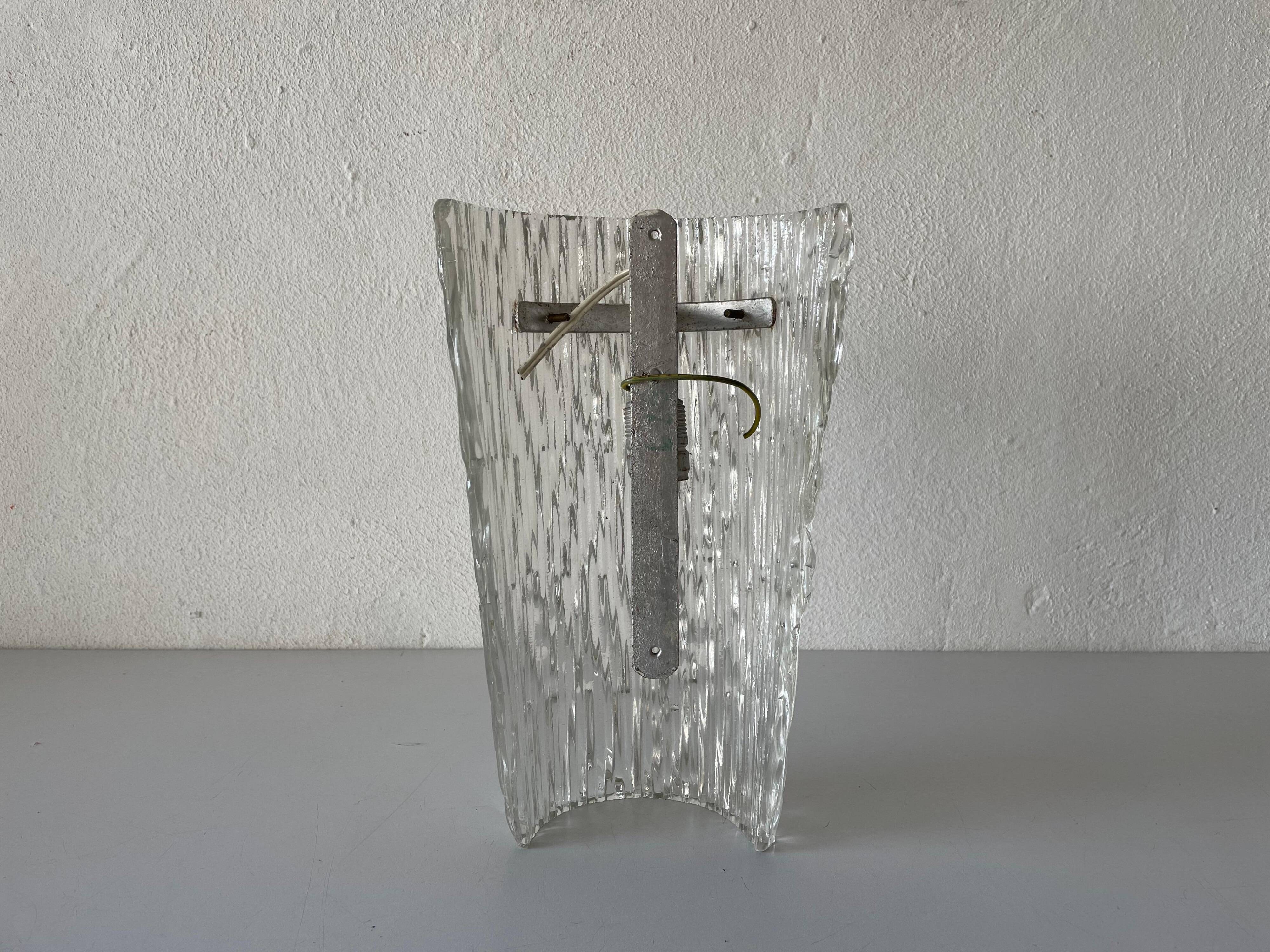 Simple arch-shaped wall light in textured glass, 1950s, Germany.