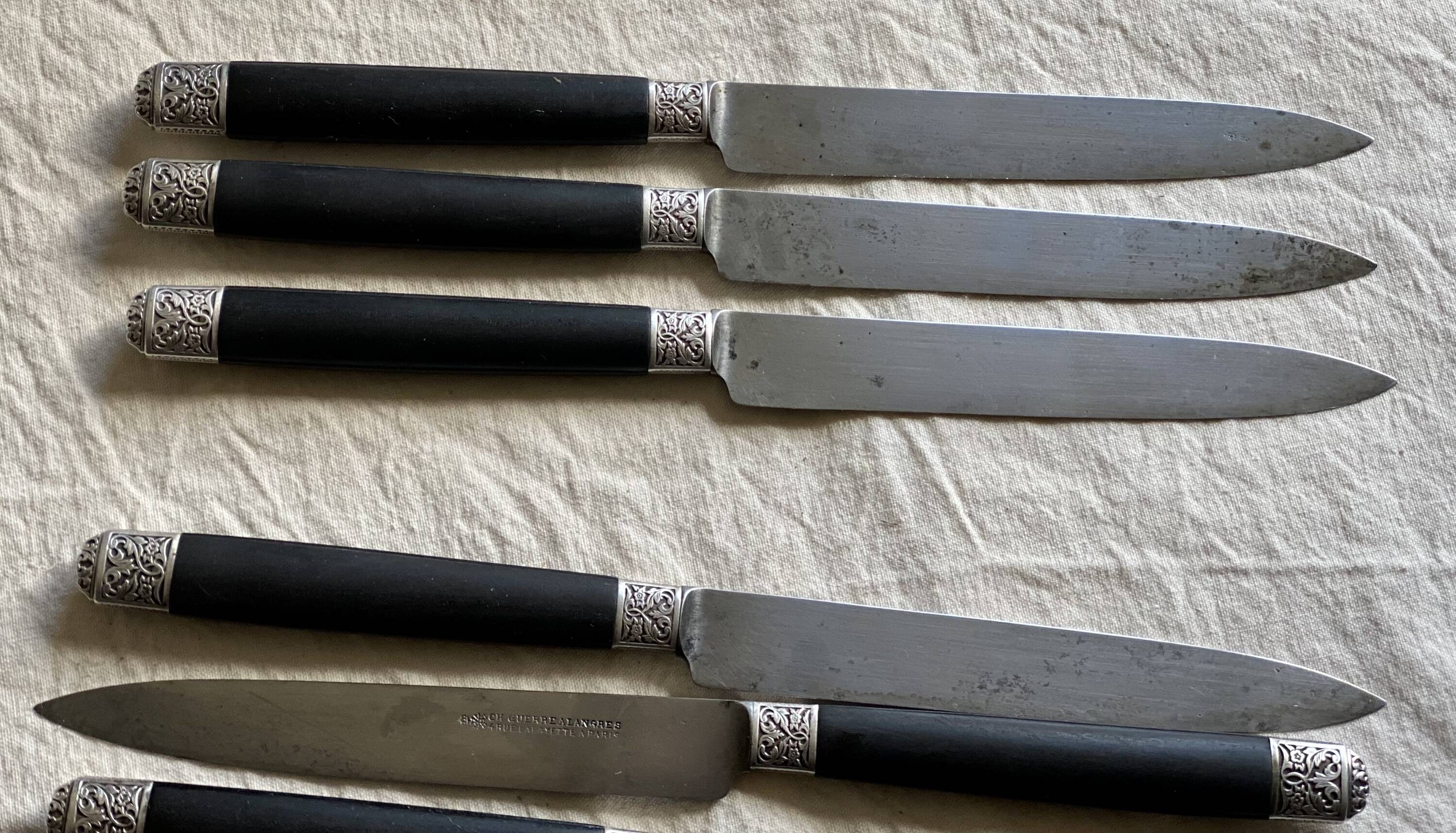 Set of 12 19th century table knives with ebony and chiseled silver handles