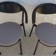 4 Gondola-style chairs with a sturdy metal frame and faux leather for