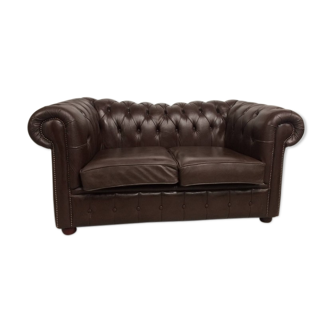 Two-seater brown leather chesterfield sofa