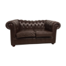 Two-seater brown leather chesterfield sofa