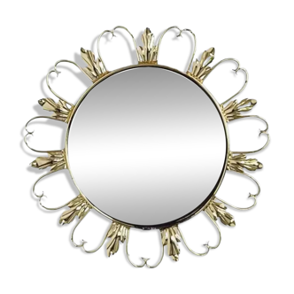Round mirror on a brass frame with scrolls