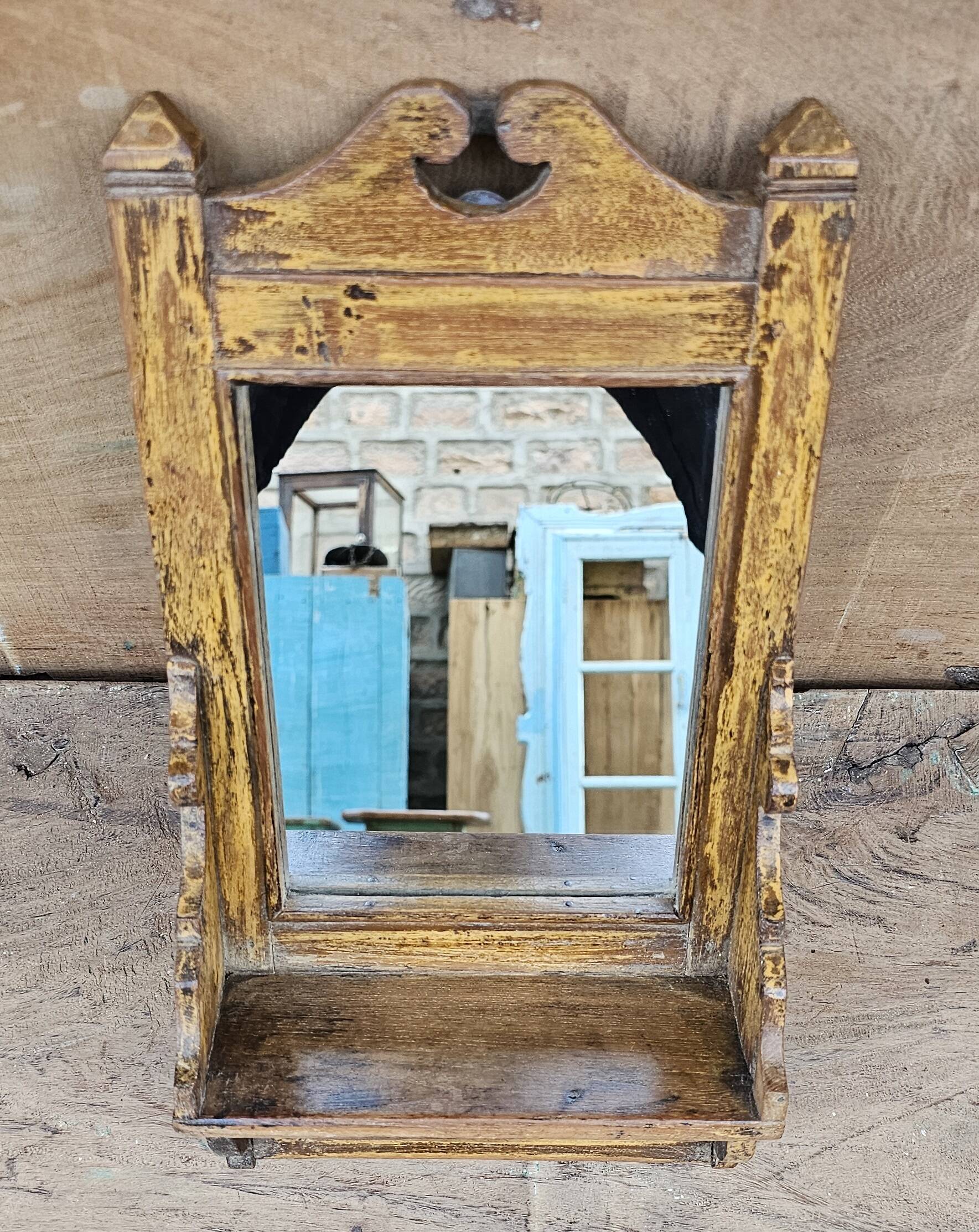 Antique barber's mirror in Burmese teak.