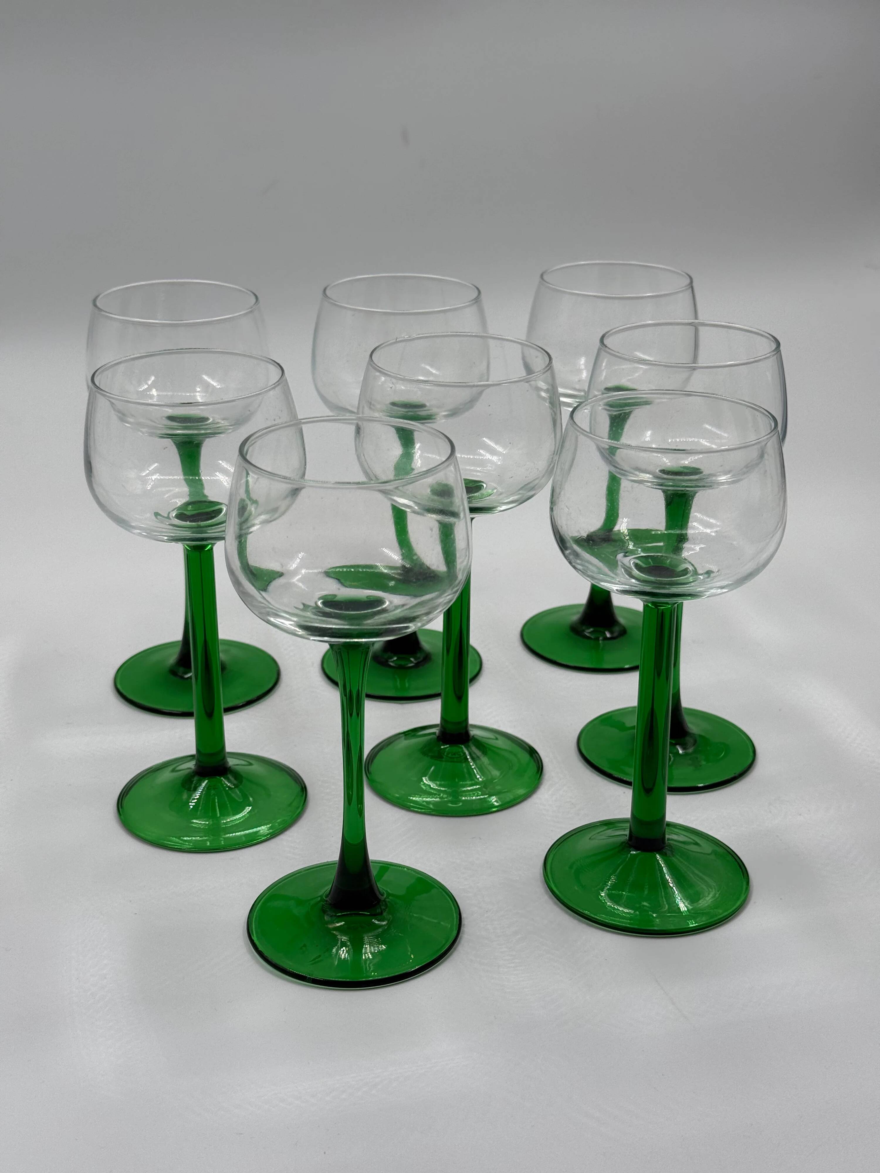 Set of 8 green stemmed wine glasses made in France.