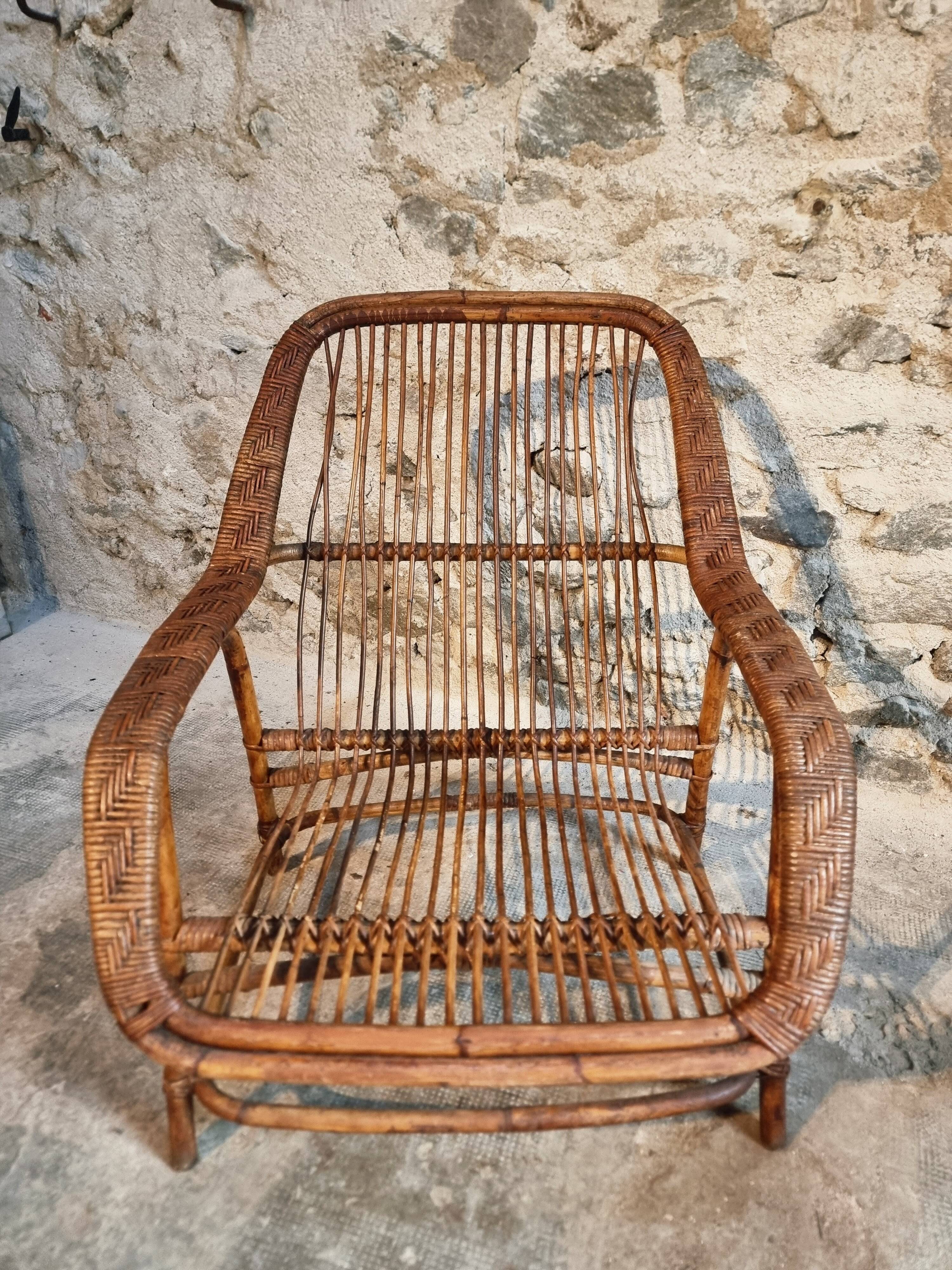 Vintage rattan lounge set, French wicker armchairs and round table, circa 1930–1950.
