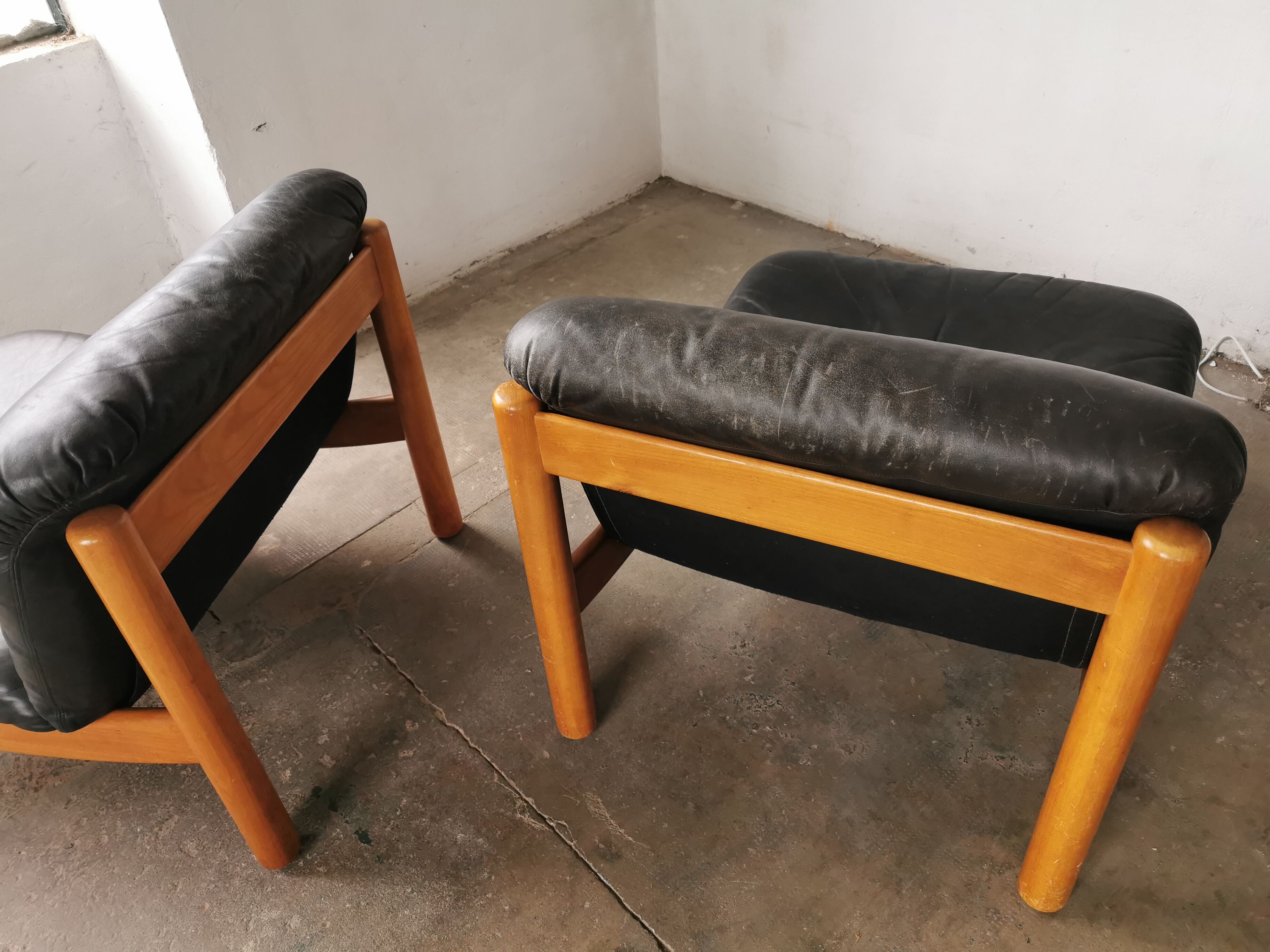 Pair of designer leather armchairs 80s