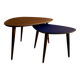 A pair of tripod and nesting coffee tables in walnut and midnight blue.