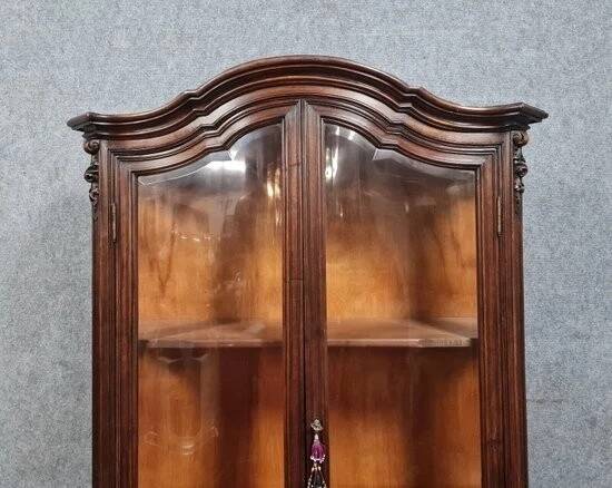 Curved library with two walnut doors, in Louis XV style.