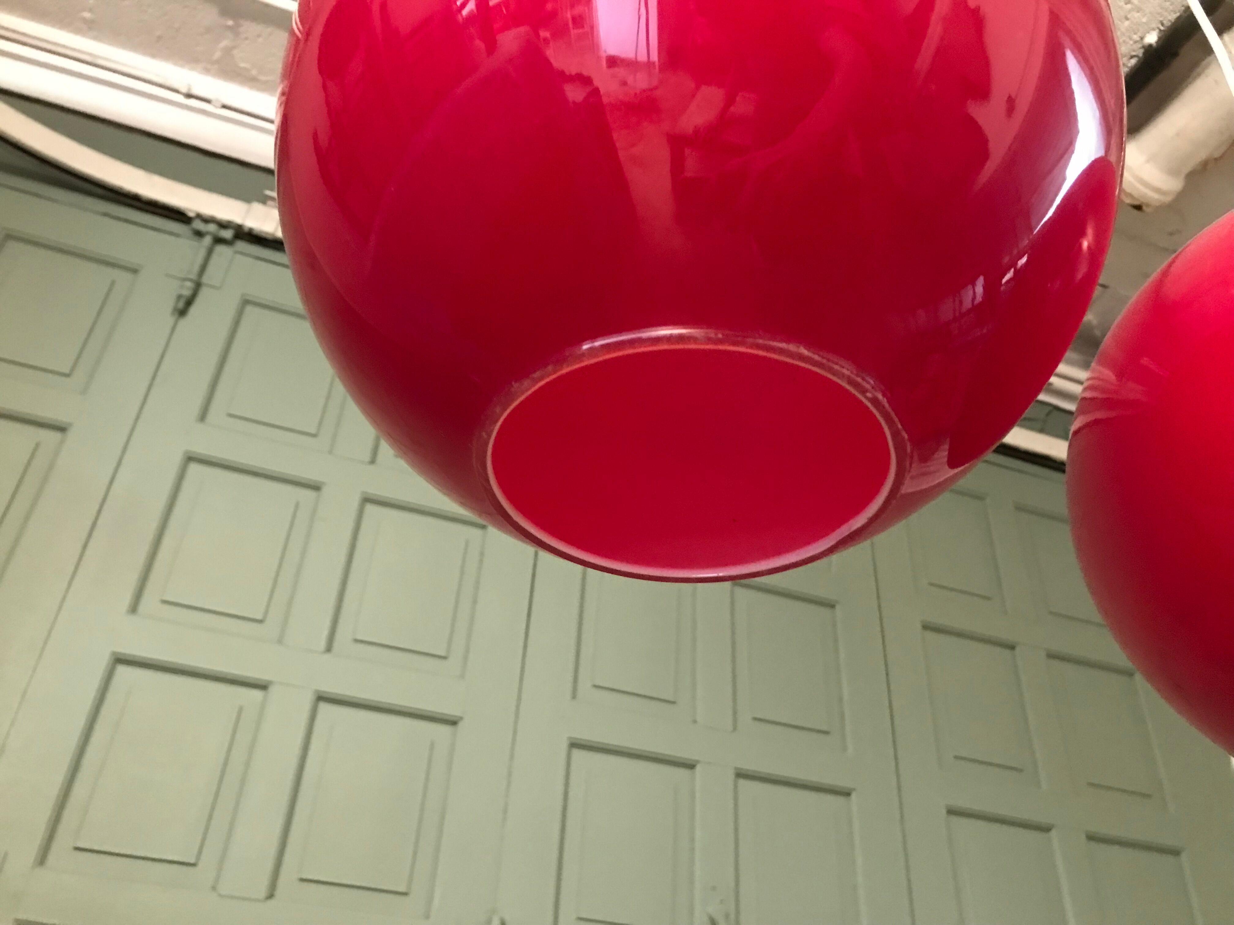 Pair of orange glass ball suspensions, 70s.