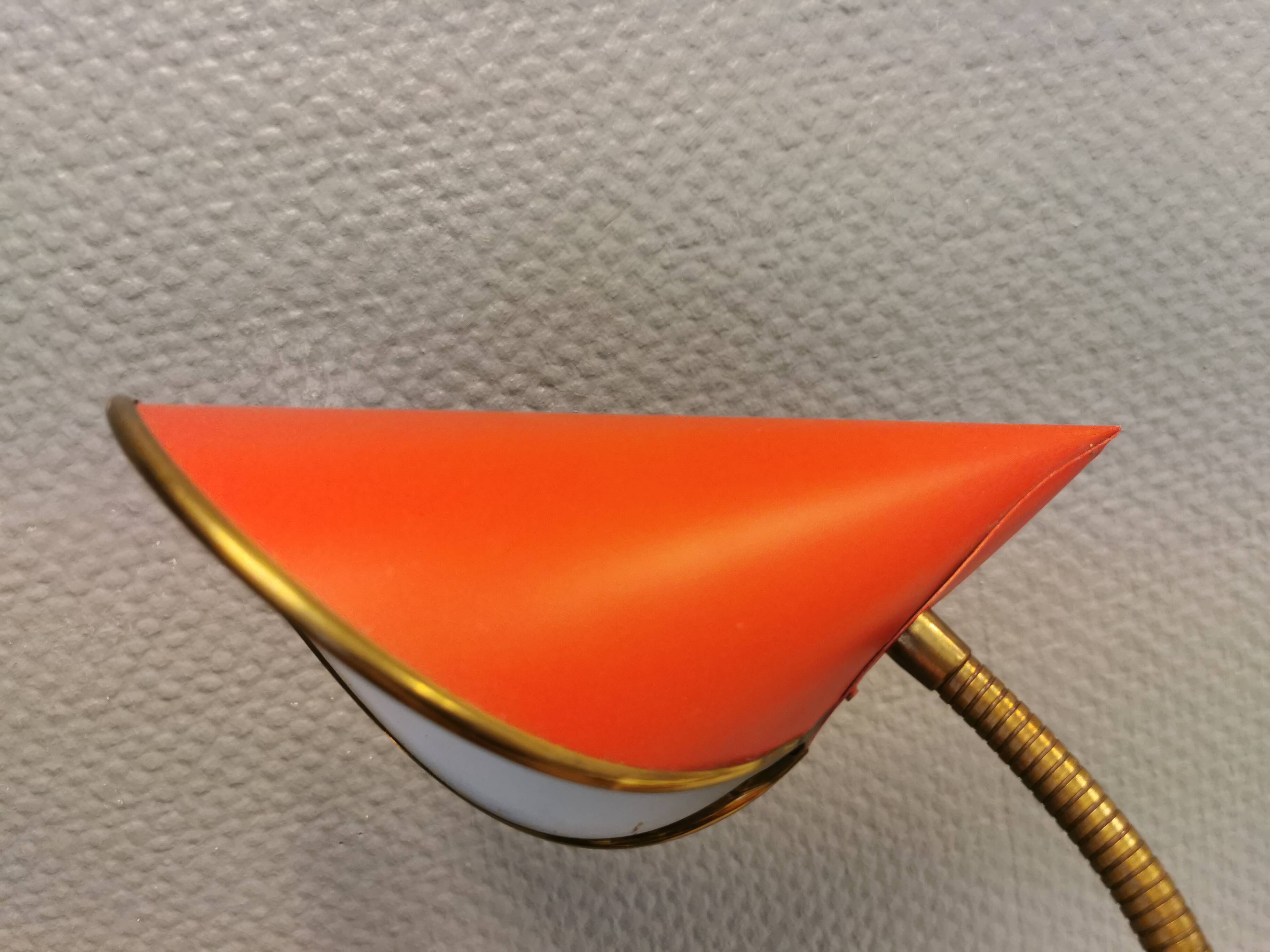 Danish red lacquered wall light with brass details. Estimated 1980s