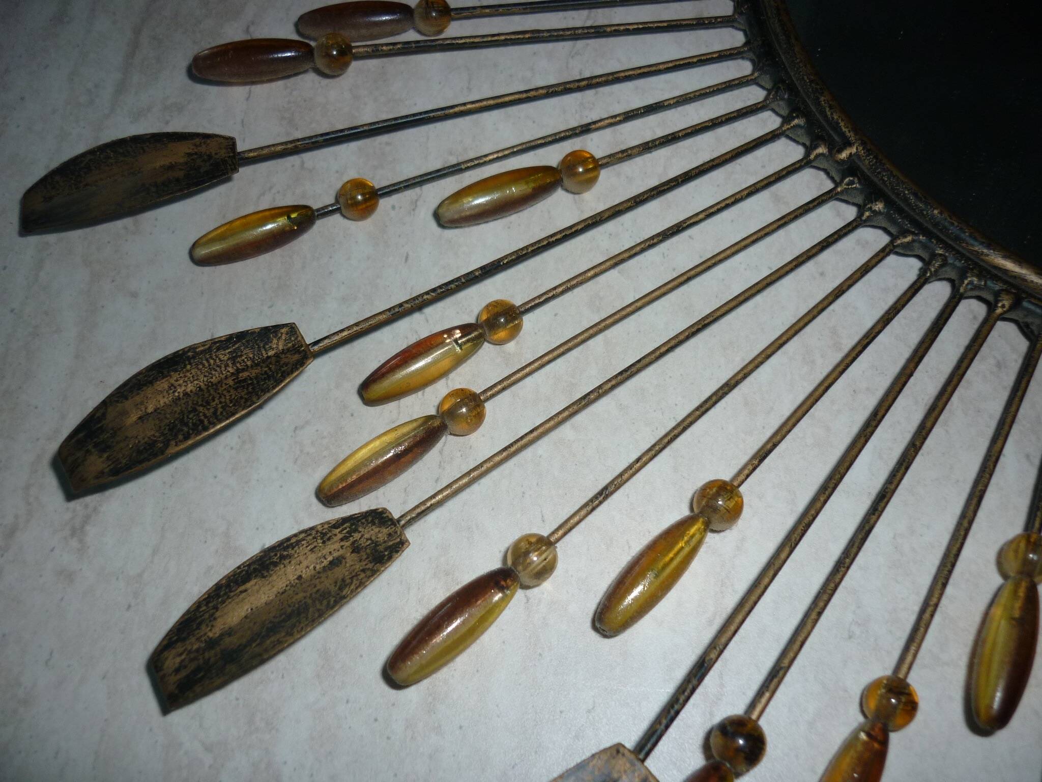 Round sun mirror with pearl rays and leaves