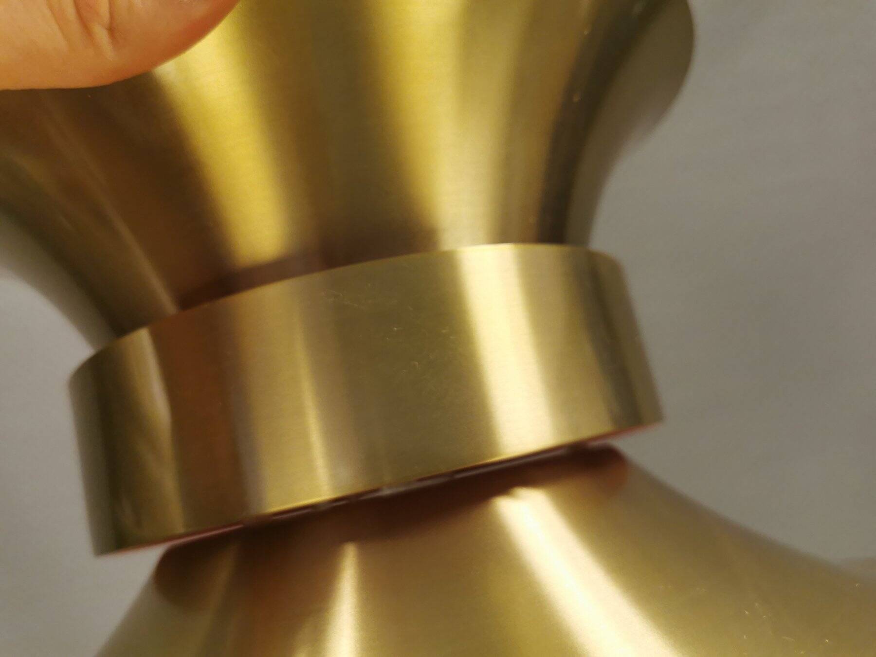 Large hanging lamp, made of brass-coloured aluminium with red and white contrast lacquer inside.