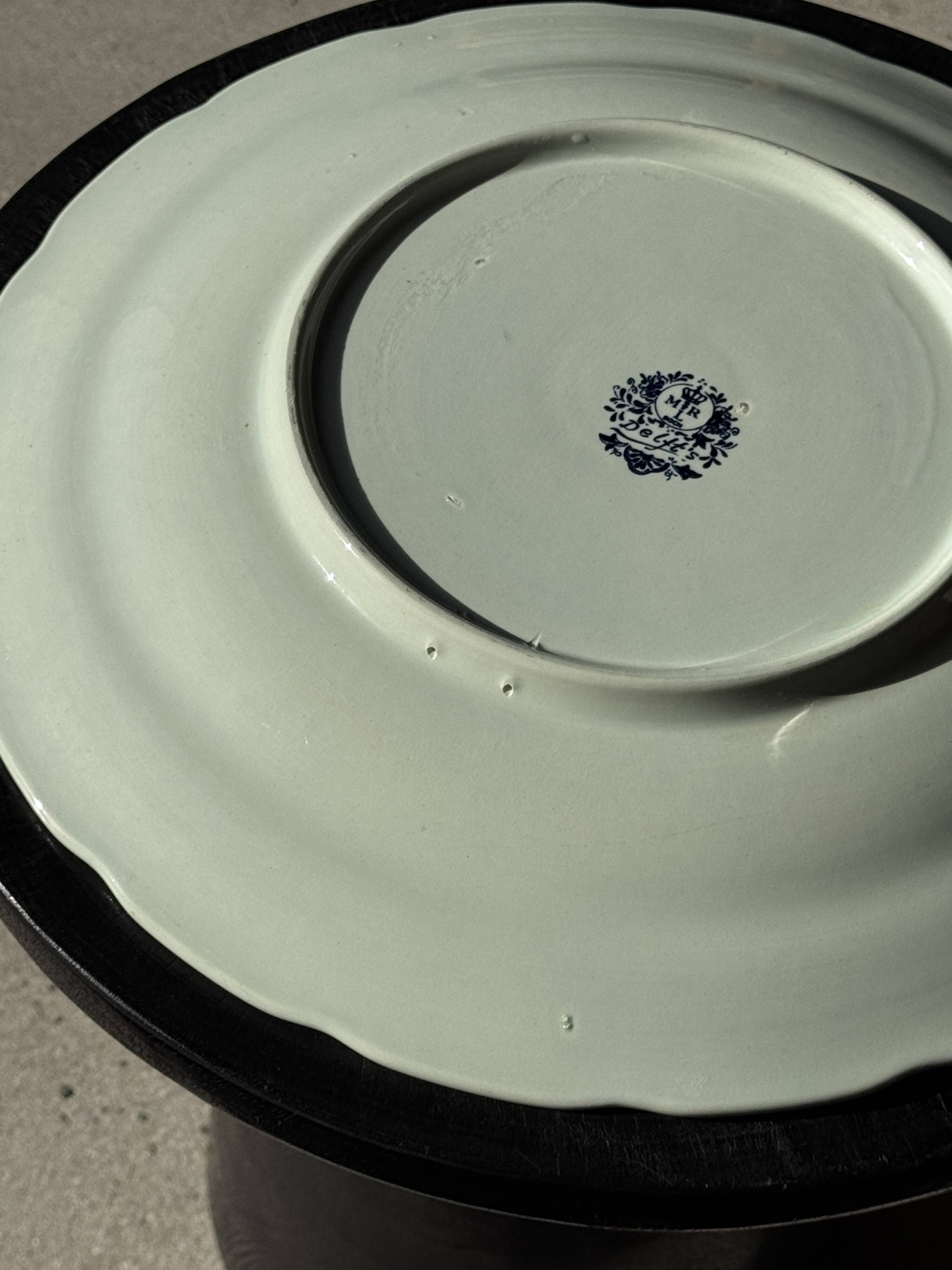 Vintage hollow circular plate in blue and white Boch pottery.