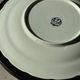 Vintage hollow circular plate in blue and white Boch pottery.