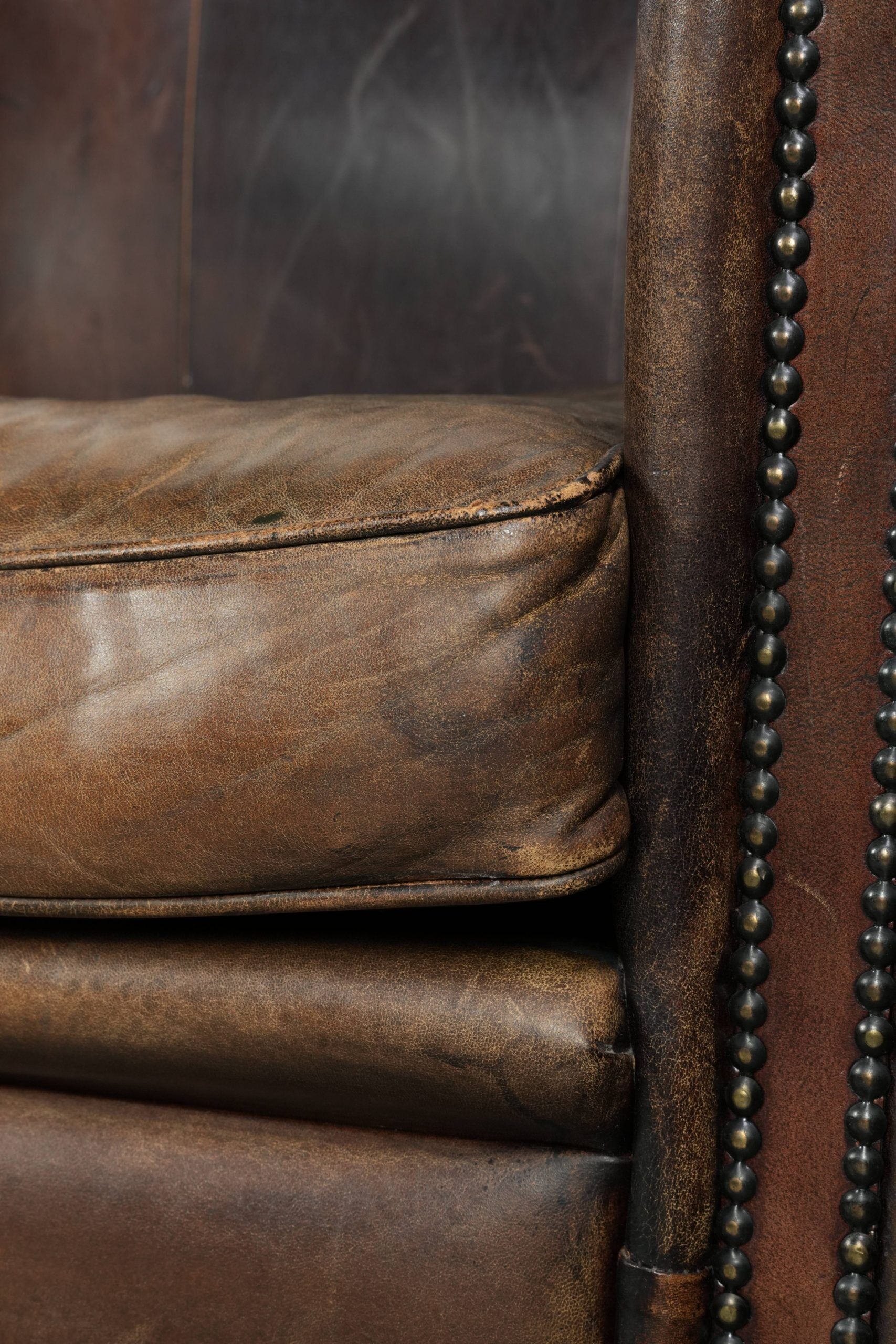 Characterful set of two sheepskin design armchairs with beautiful patina