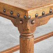 Brutalist coffee table in solid oak, metal, and patinated leather, 1940s.