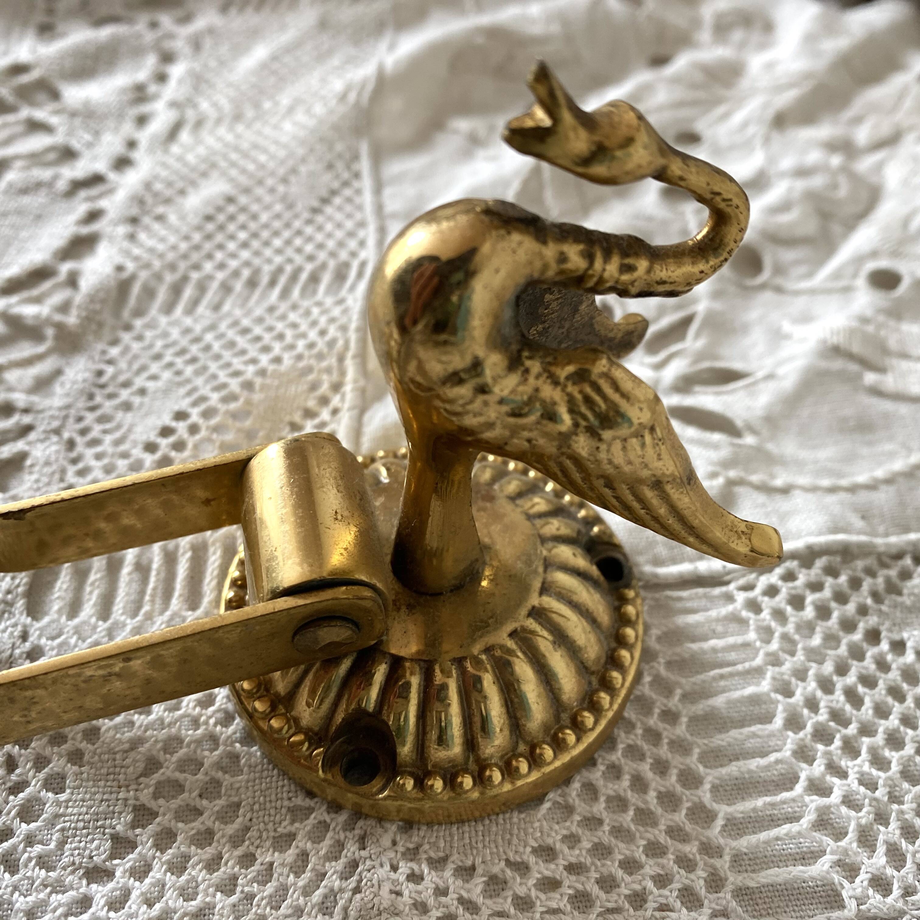Swan toilet paper dispenser in brass