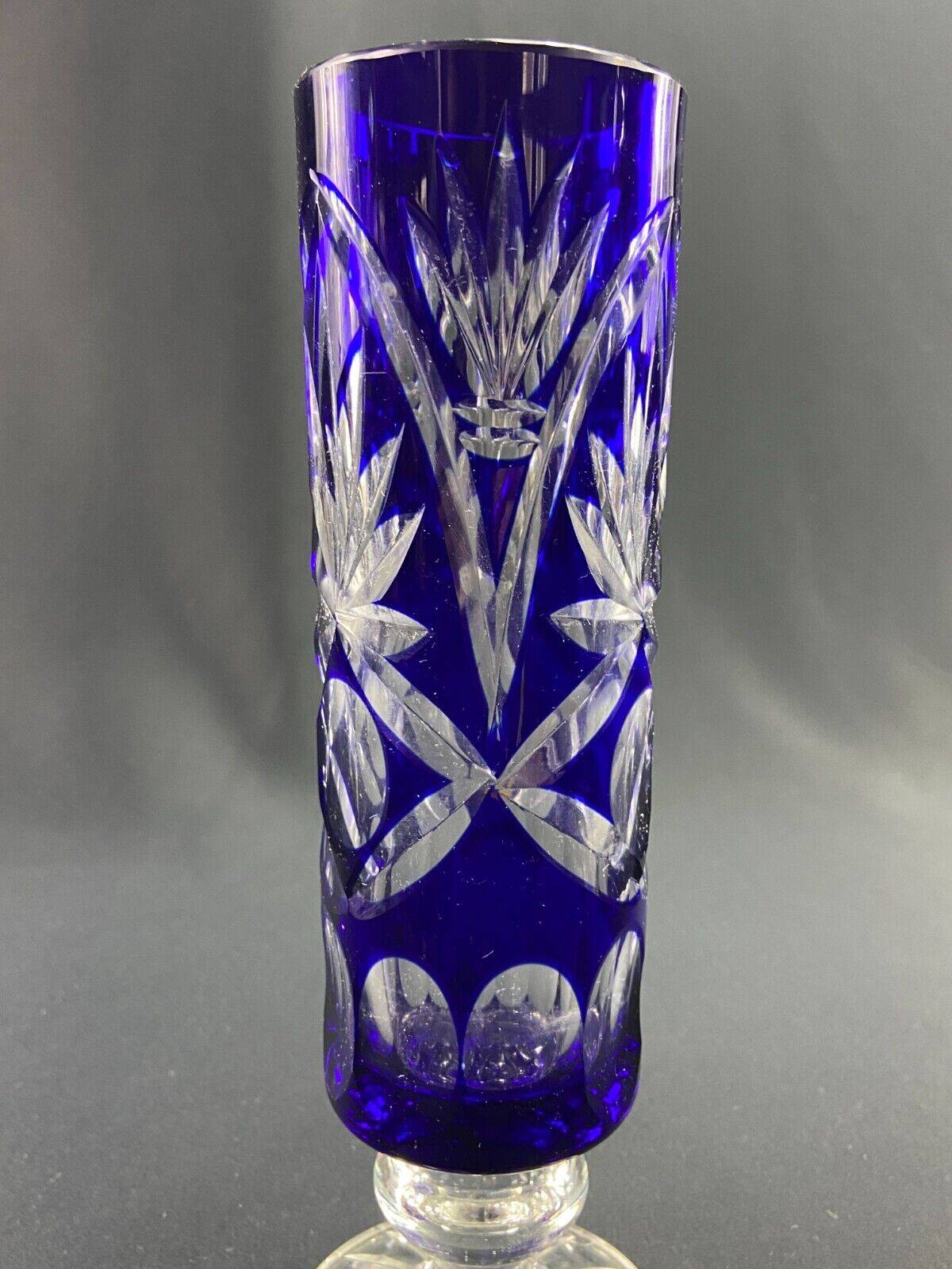 Tubular vase on a pedestal in cut blue Bohemian crystal.