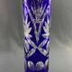 Tubular vase on a pedestal in cut blue Bohemian crystal.