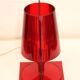 Red plastic Kartell table lamp - model Take - design by Ferruccio Laviani
